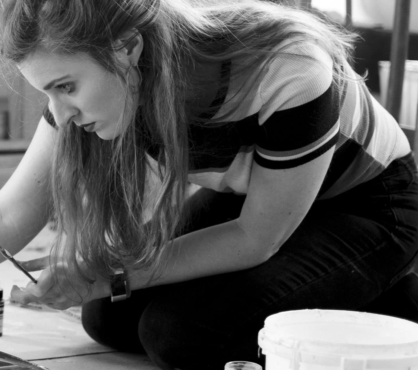 Danielle Mužina painting in the studio